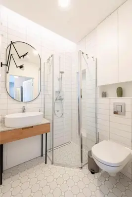 a bathroom with a sink and a toilet and a mirror at 1bdr Apt w/Balcony, free Pkg in Vilnius