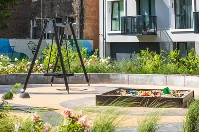 a playground in a garden with a swing at 1bdr Apt w/Balcony, free Pkg in Vilnius