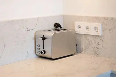 a toaster sitting on a counter in a kitchen at 1bdr Apt w/Balcony, free Pkg in Vilnius