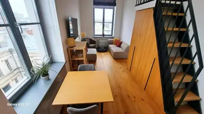 a living room with a table and a couch at KaunasInn - AM in Kaunas