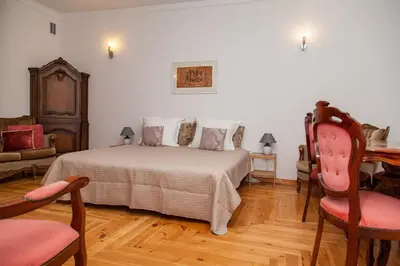 a bedroom with a bed and a table and chairs at KaunasInn - AM in Kaunas