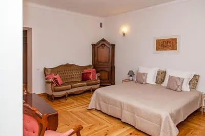a bedroom with a bed and a couch in it at KaunasInn - AM in Kaunas