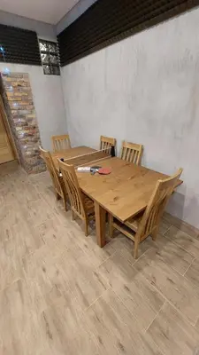 a wooden table and chairs in a room at Fun and chill patalpu ir pirties nuoma in Vilnius