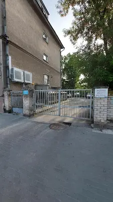 a fence in front of a building with two air conditioners at Fun and chill patalpu ir pirties nuoma in Vilnius