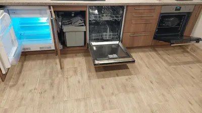a kitchen with an open refrigerator and a wooden floor at Fun and chill patalpu ir pirties nuoma in Vilnius
