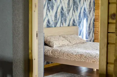 a small bed in a room with a window at Hotel resort Sedula in Skogalis