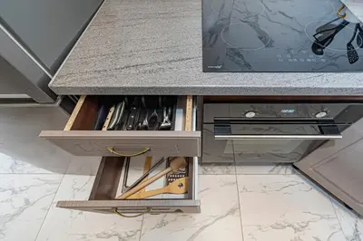 a kitchen with a counter with a drawer at Prestigious city center apartment with free parking by Polo Apartments in Kaunas