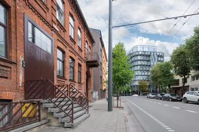 a brick building with a staircase on the side of a street at Prestigious city center apartment with free parking by Polo Apartments in Kaunas