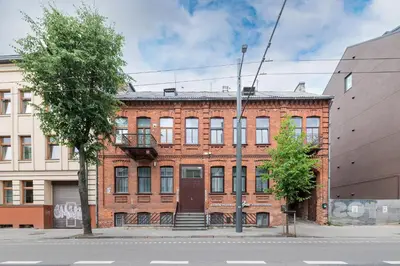 a red brick building on the corner of a street at Prestigious city center apartment with free parking by Polo Apartments in Kaunas
