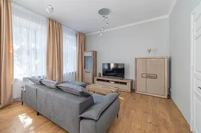 a living room with a couch and a flat screen tv at Prestigious city center apartment with free parking by Polo Apartments in Kaunas