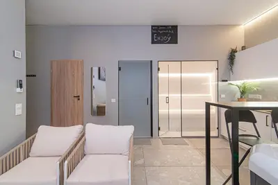 a room with two white chairs and a table at Secret SPA in Vilnius