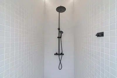 a shower with a shower head in a bathroom at Secret SPA in Vilnius