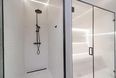 a shower with a glass door in a bathroom at Secret SPA in Vilnius