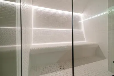 a shower with a glass door in a bathroom at Secret SPA in Vilnius