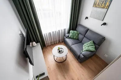 a living room with a couch and a table at Juozapaviciaus apartment in Kaunas