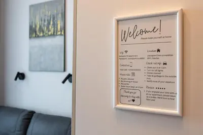a sign on a wall with a welcome sign on it at Juozapaviciaus apartment in Kaunas