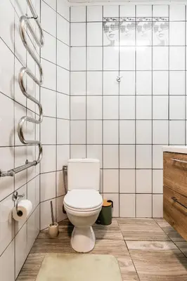 a white bathroom with a toilet and a sink at Juozapaviciaus apartment in Kaunas