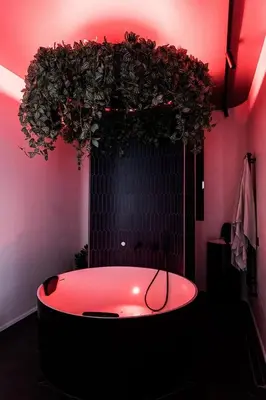 a bathroom with a bath tub with red lighting at Butas su Jacuzzi Kauno miesto centre in Kaunas
