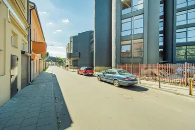 a car parked on a street next to a building at Butas su Jacuzzi Kauno miesto centre in Kaunas