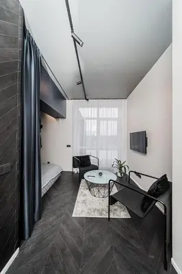 a living room with a table and a couch at Butas su Jacuzzi Kauno miesto centre in Kaunas