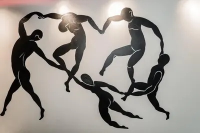 a group of silhouettes of people dancing on a wall at Butas su Jacuzzi Kauno miesto centre in Kaunas