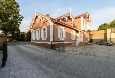 a building with a car parked in front of it at Vila Arnika in Druskininkai