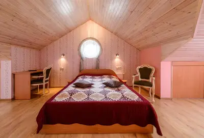 a bedroom with a bed and a desk and a window at Vila Arnika in Druskininkai