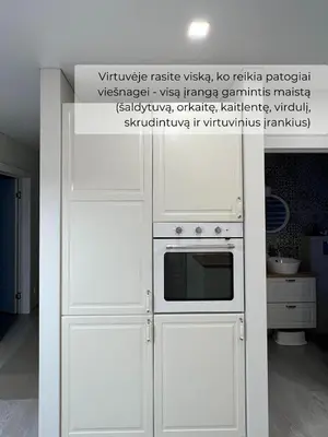 a kitchen with a white refrigerator and a microwave at Palūšės Apartment in Palūšė