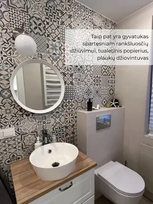 a bathroom with a sink and a mirror at Palūšės Apartment in Palūšė
