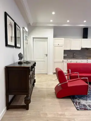 a living room with a red couch and a red chair at NERIS Apartments in Vilnius