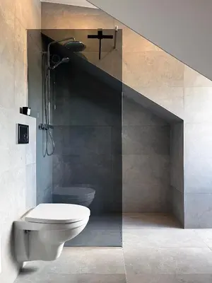 a bathroom with a toilet and a sink and a staircase at NERIS Apartments in Vilnius
