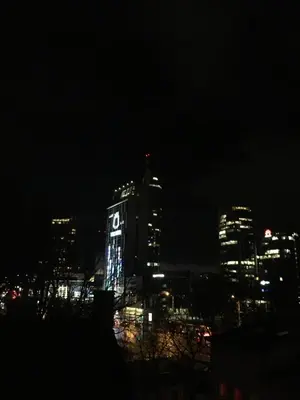a city skyline at night with a clock tower at NERIS Apartments in Vilnius