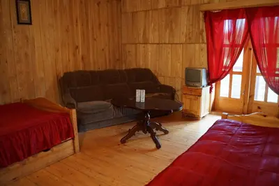 a living room with a couch and a table at Meškiai in Meškiai