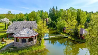 an aerial view of a house in the middle of a river at Meškiai in Meškiai