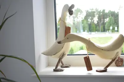 two wooden toy horses sitting on a window sill at Big Mama Koala in Druskininkai