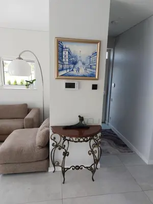 a living room with a table and a couch at Big Mama Koala in Druskininkai