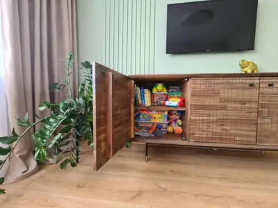 a television on top of a book shelf in a room at Samanų apartamentai in Šiauliai