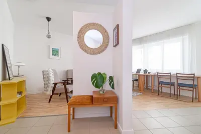 a living room with a table and a mirror at Slow-down, relax, take it easy in artsy Oasy in Vilnius