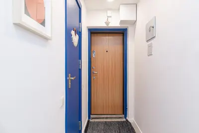 a hallway with a wooden door in a building at Slow-down, relax, take it easy in artsy Oasy in Vilnius