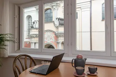 a laptop sitting on a table in front of a window at Slow-down, relax, take it easy in artsy Oasy in Vilnius