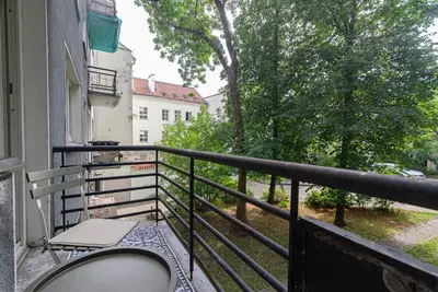 a balcony with a table and a view of a street at Slow-down, relax, take it easy in artsy Oasy in Vilnius