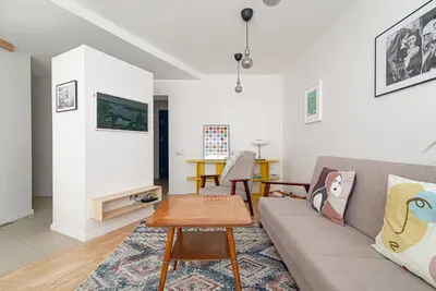 a living room with a couch and a table at Slow-down, relax, take it easy in artsy Oasy in Vilnius