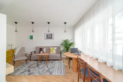 a living room with a table and a couch at Slow-down, relax, take it easy in artsy Oasy in Vilnius