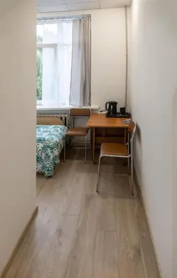 a room with a table and chairs and a window at Mini Studio Vilnius Centre in Vilnius