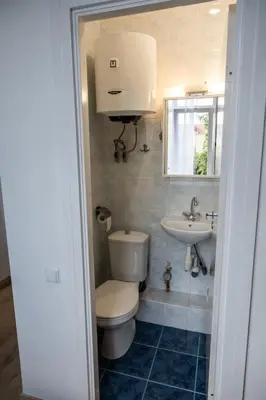 a bathroom with a toilet and a sink at Mini Studio Vilnius Centre in Vilnius