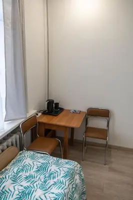 a room with a table and chairs and a table and a bed at Mini Studio Vilnius Centre in Vilnius