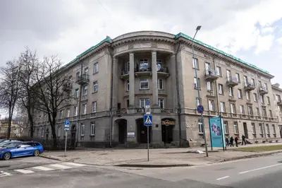 a large stone building on the corner of a street at Mini Studio Vilnius Centre in Vilnius