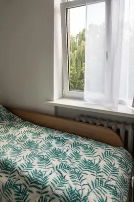 a bed in a room with a window at Mini Studio Vilnius Centre in Vilnius