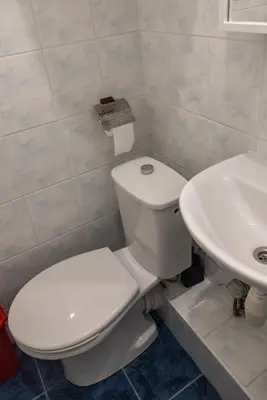 a bathroom with a white toilet and a sink at Mini Studio Vilnius Centre in Vilnius