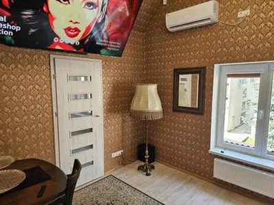 a room with a table and a window and a picture at Square apartments in Rokiškis
